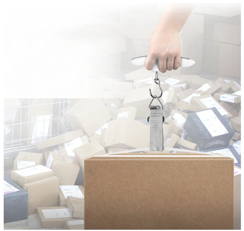 The AirportPRO digital hanging luggage scale with LCD screen being used for gauging box weight in the office mail room.