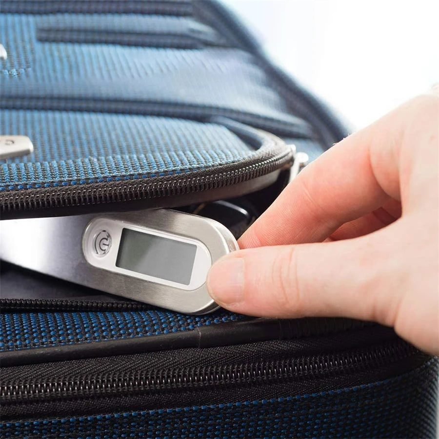 'AirportPRO Digital Scale' sliding into suitcase pocket showing the sleek and portable design for ultimate convenience.