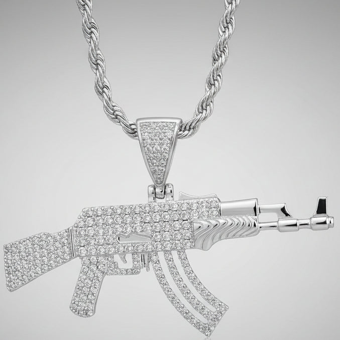 Silver AK47 gun-shaped pendant on rope chain necklace over a dark red background.