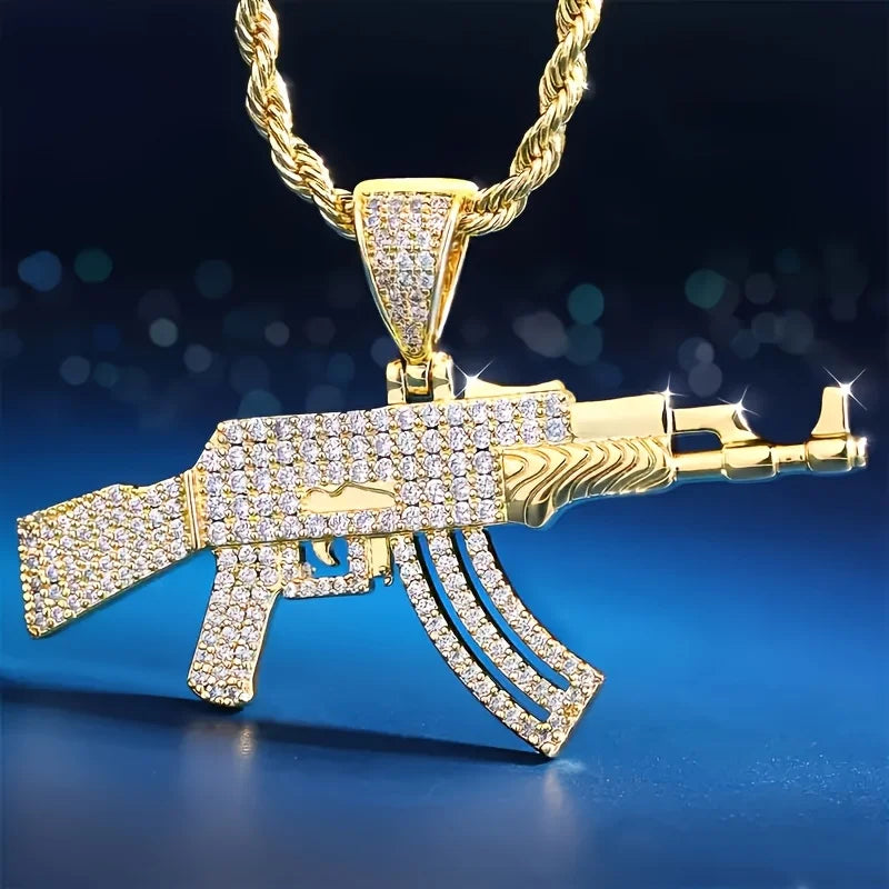 Gold and diamond-encrusted AK47 gun-shaped pendant on a blue and black gradient background