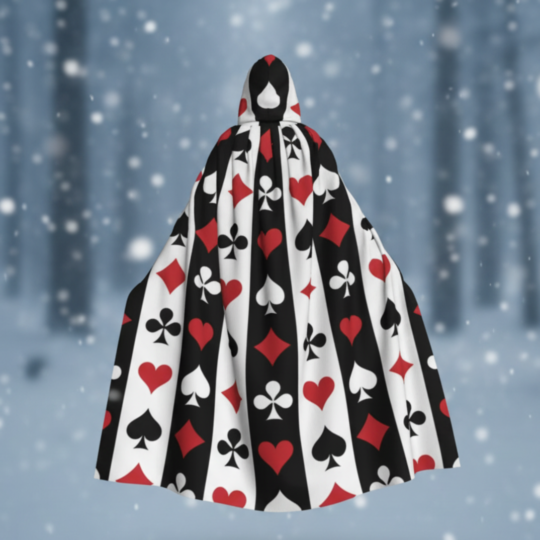 Person wearing a black, red, and white playing card patterned cape in a snowy forest setting.
