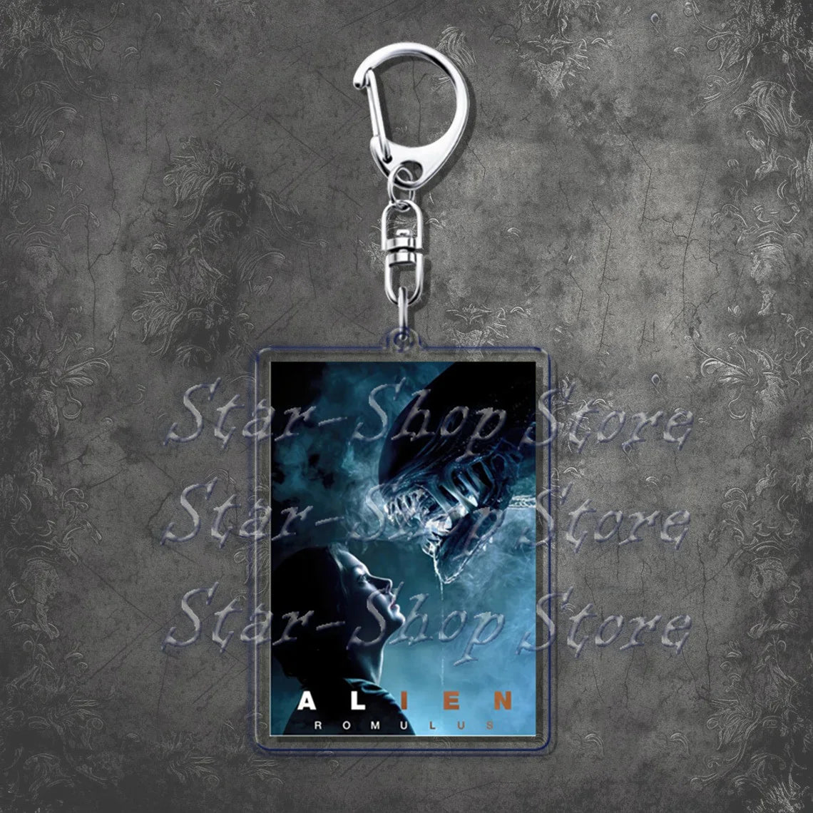 Keychain with 'Alien' movie poster design on a textured gray background