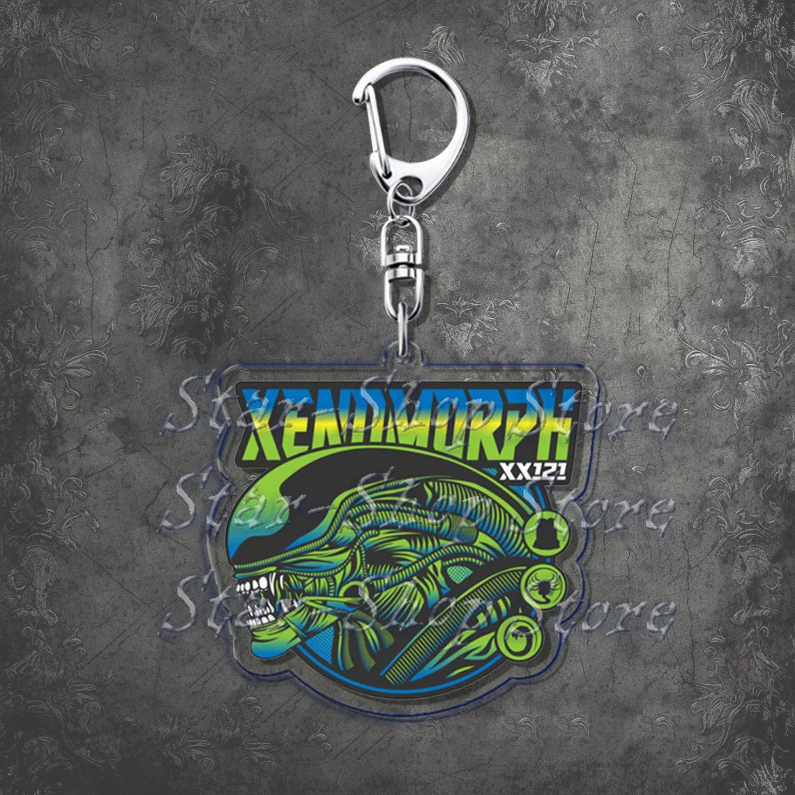 Keychain with Xenomorph design on a textured gray background