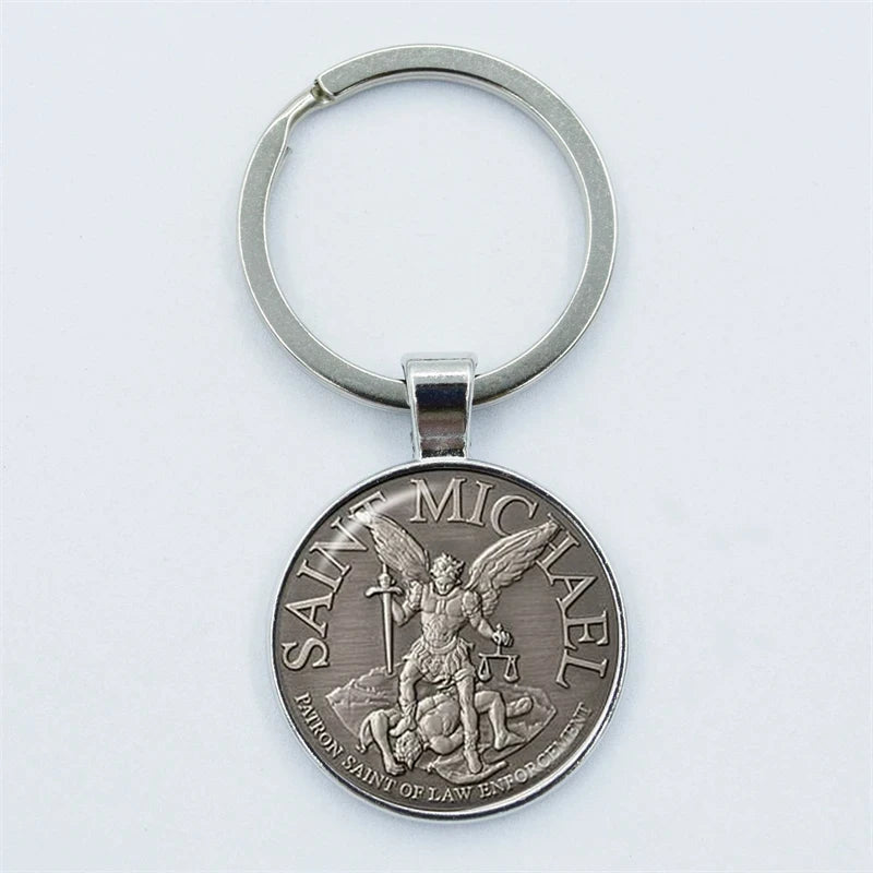 Silver keychain with Saint Michael design on a white background