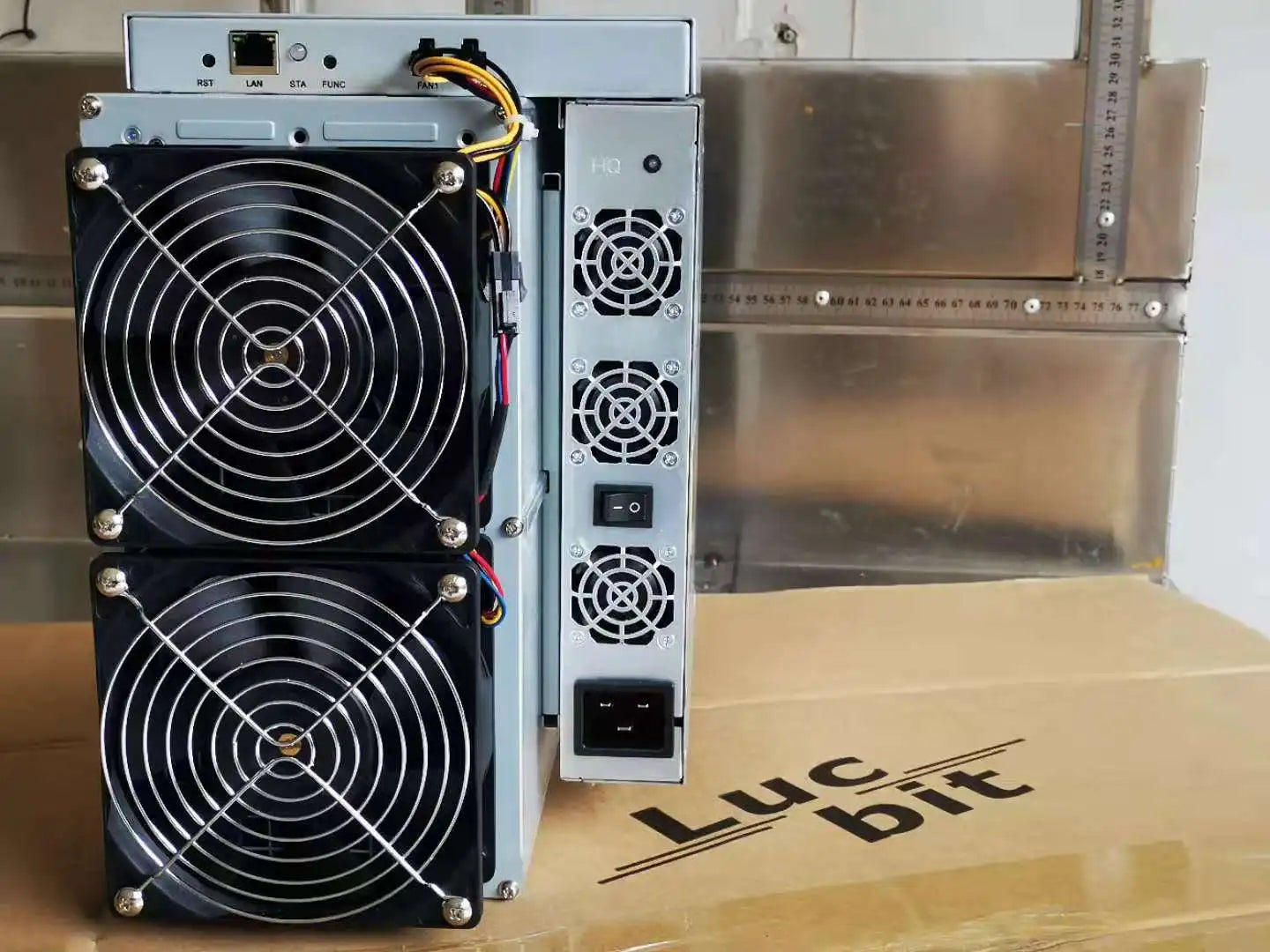 Two computer cases with fans on a Lucid Bit branded box