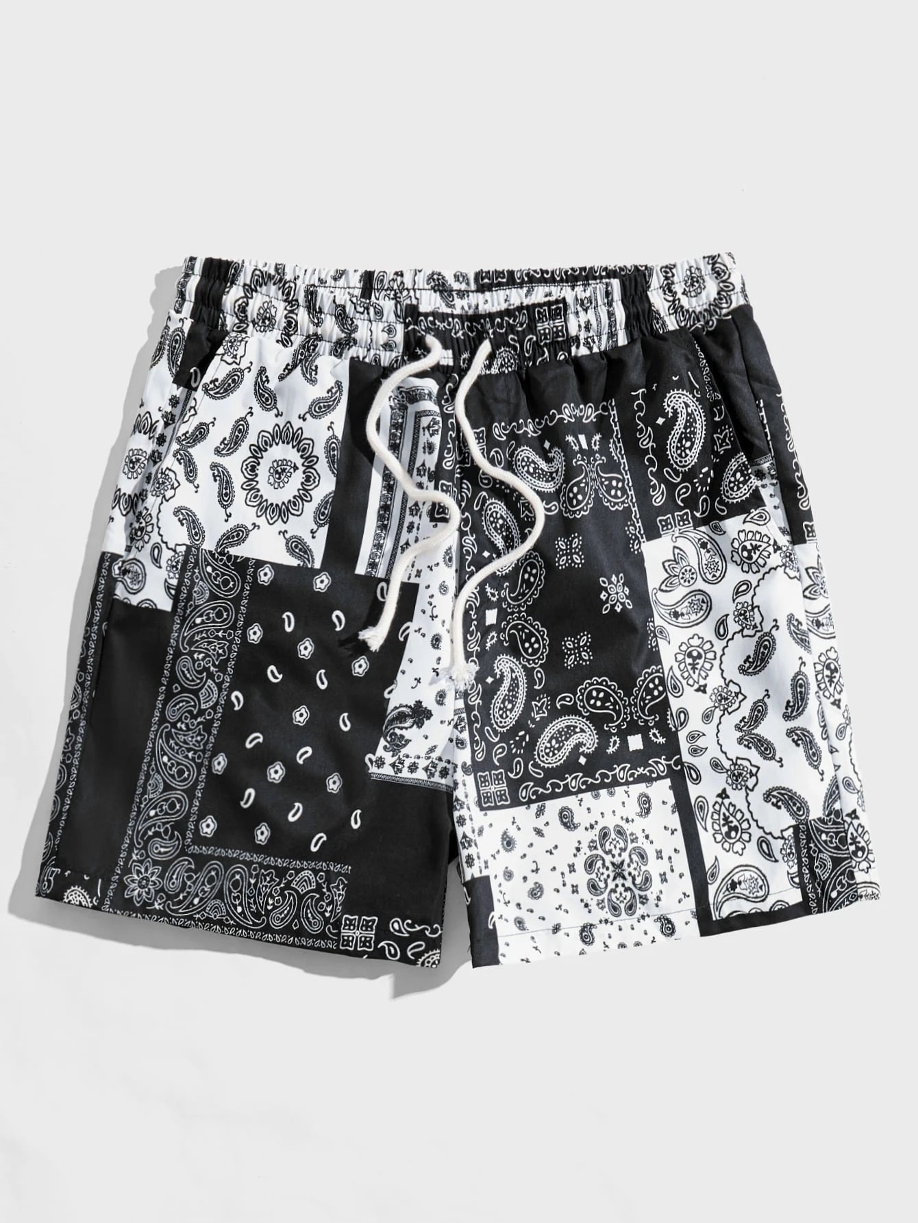 Black and white paisley patterned bandana shorts on a light gray background.