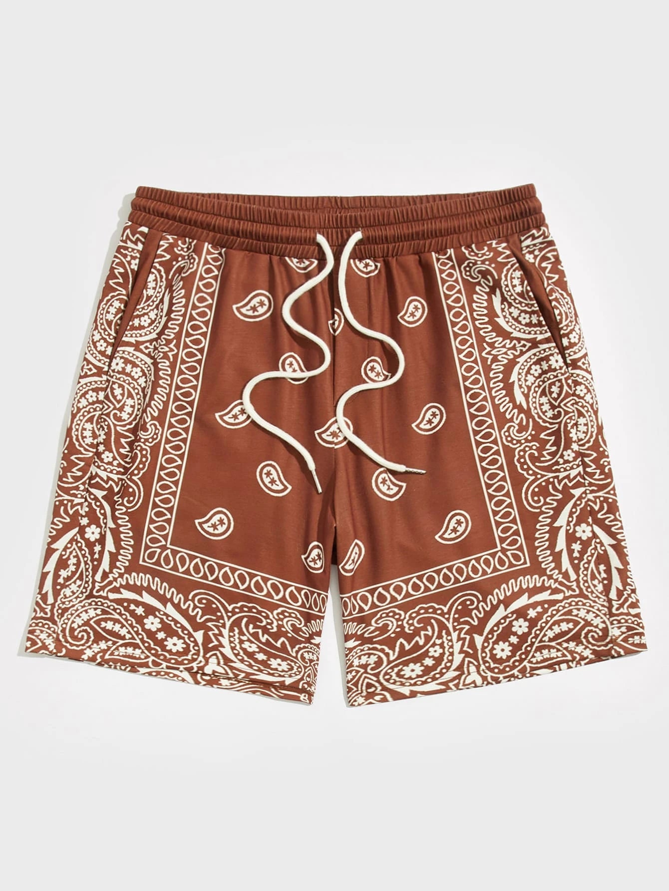Burnt orange shorts with white paisley pattern on a white background