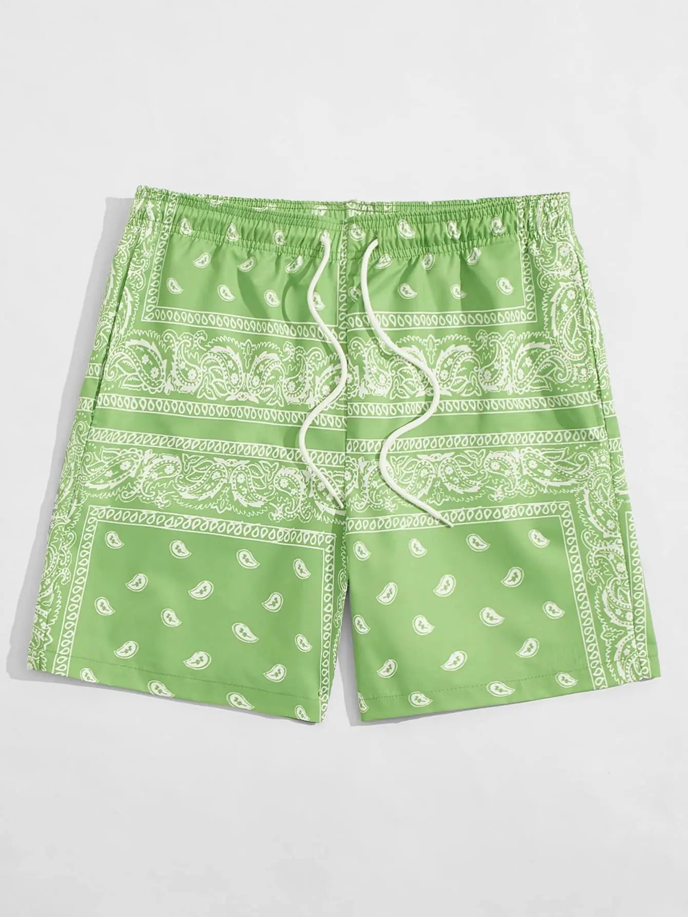 Green shorts with white bandana pattern on a light gray background