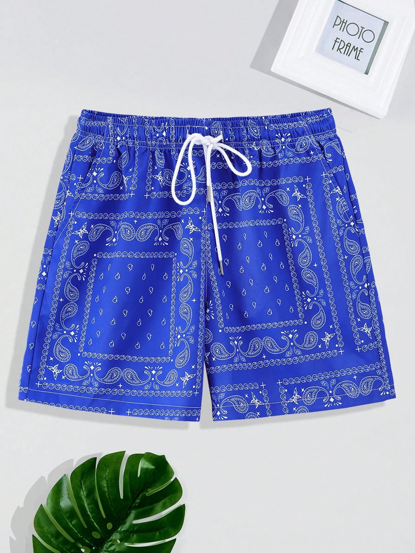Blue shorts with white pattern on a light gray background