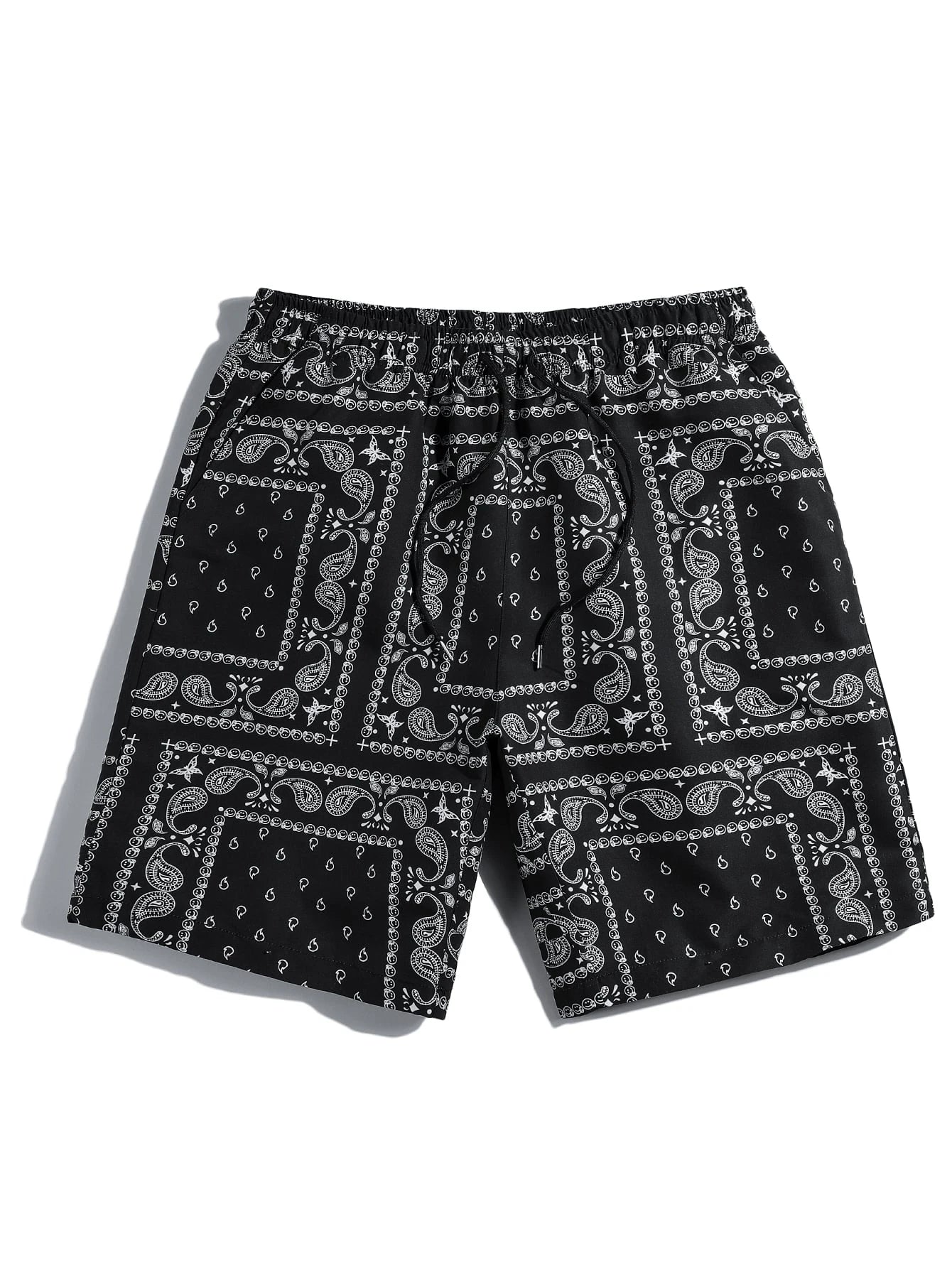 Black and white bandana patterned paisley shorts on a white background