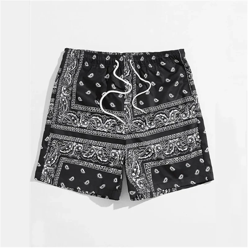 Black shorts with white paisley pattern on a white background