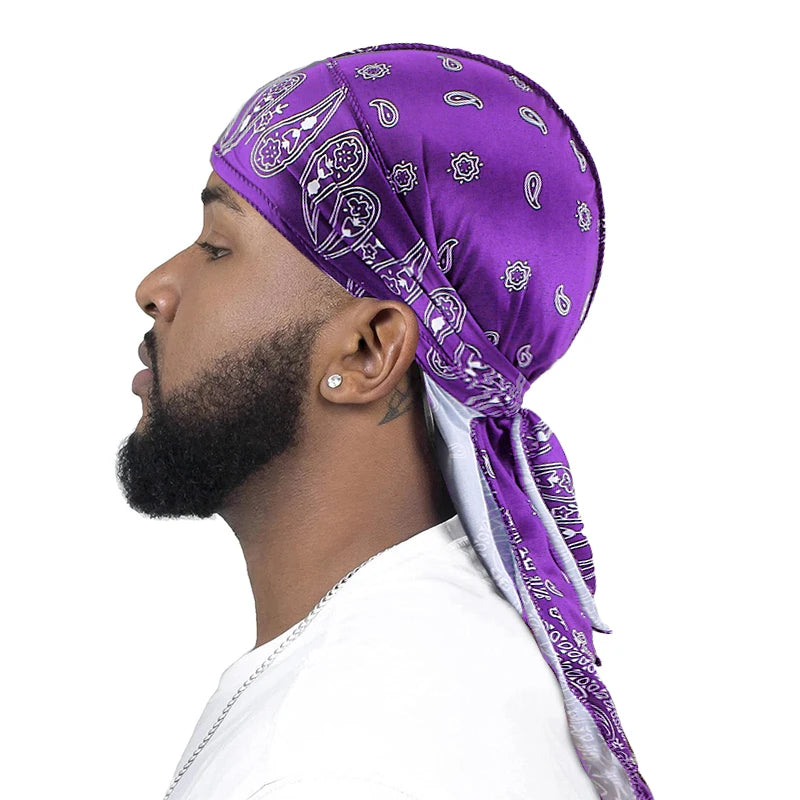 Man wearing a purple bandana durag with white patterns on a white background