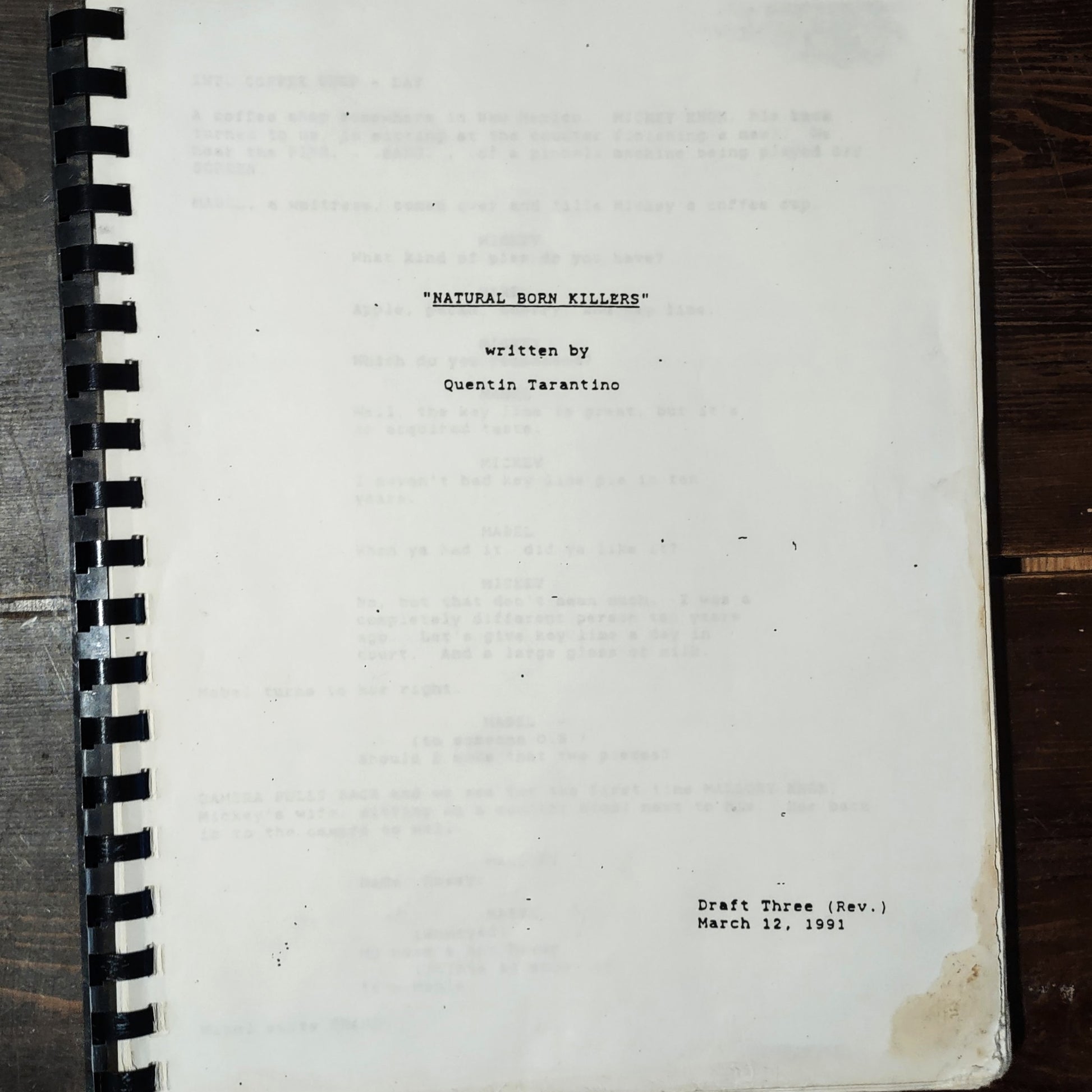 Script titled 'Natural Born Killers' by Quentin Tarantino on a wooden surface