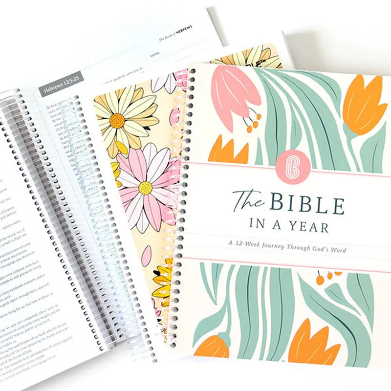 Floral-themed planner with 'The Bible in a Year' title on a white background