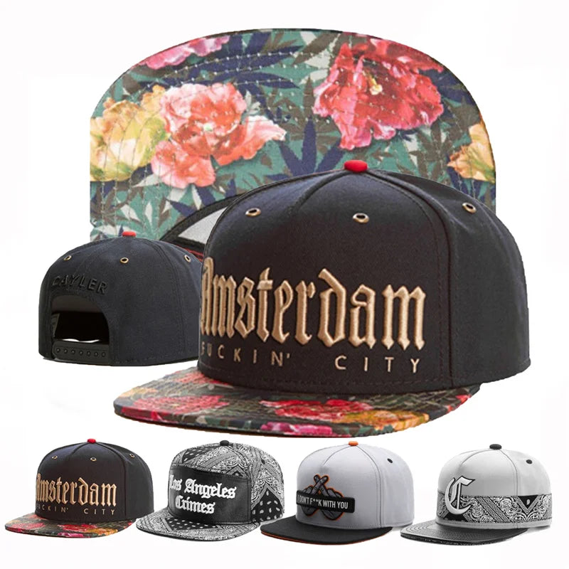 Collection of black caps with floral and text designs on a white background