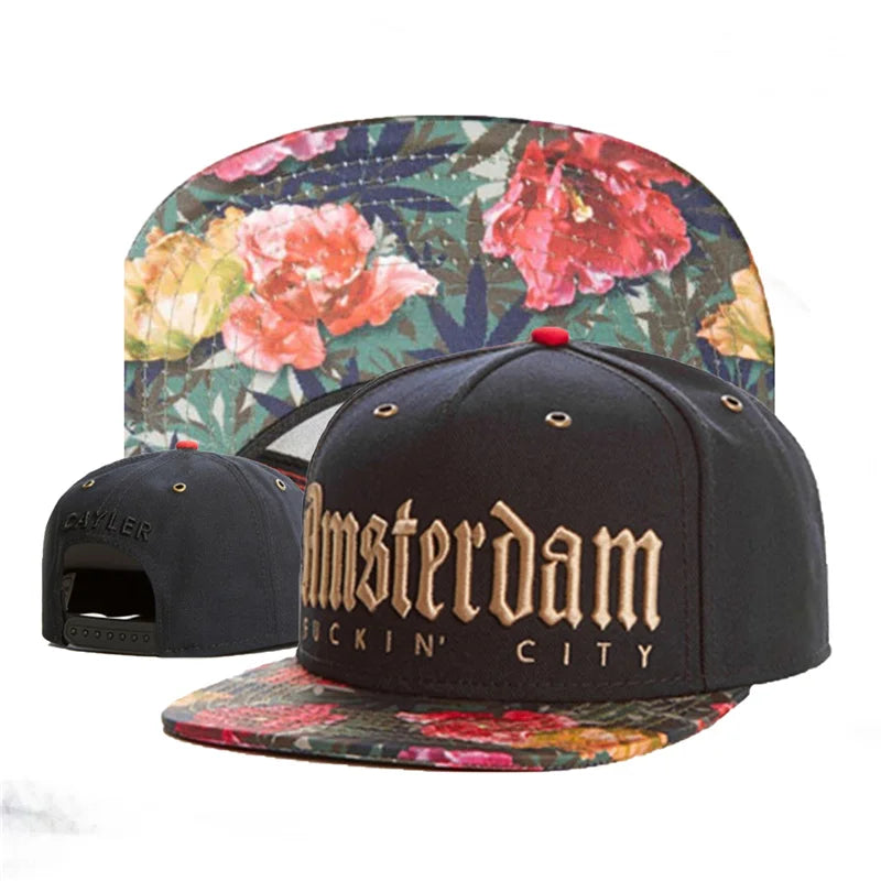 Black cap with 'Amsterdam F****n' City' text and floral pattern on a white background