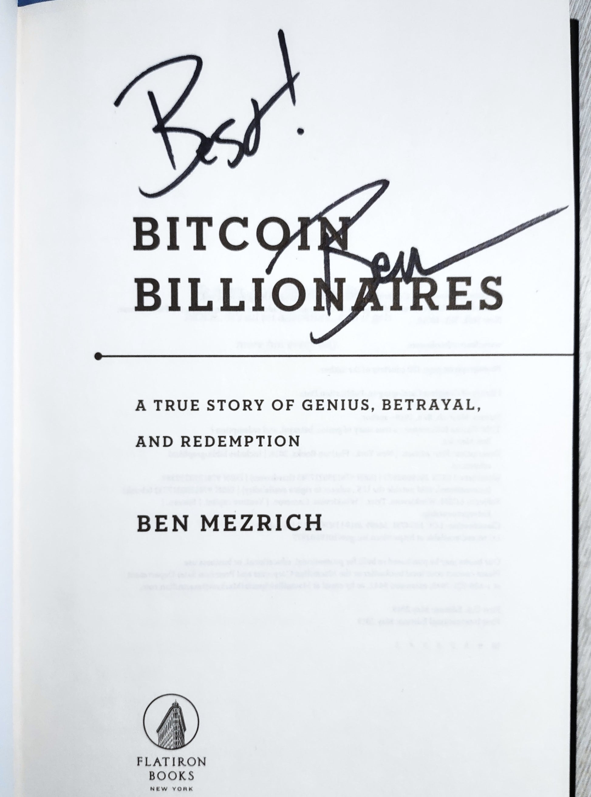 Book title page of 'Bitcoin Billionaires' by Ben Mezrich with his signature on a white page over title