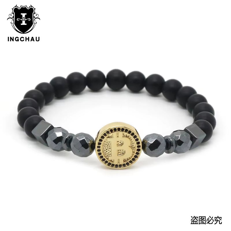 A black bead bracelet with a central Bitcoin emblem, flanked by darker and lighter beads, branded by Hematite Healing & Crypto Creations.