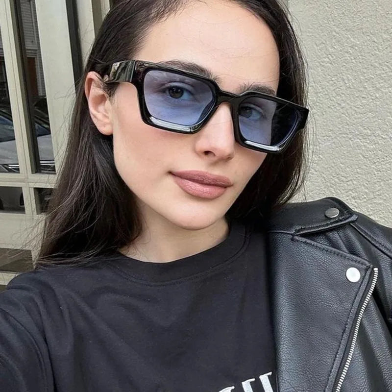Person wearing sunglasses and a black leather jacket