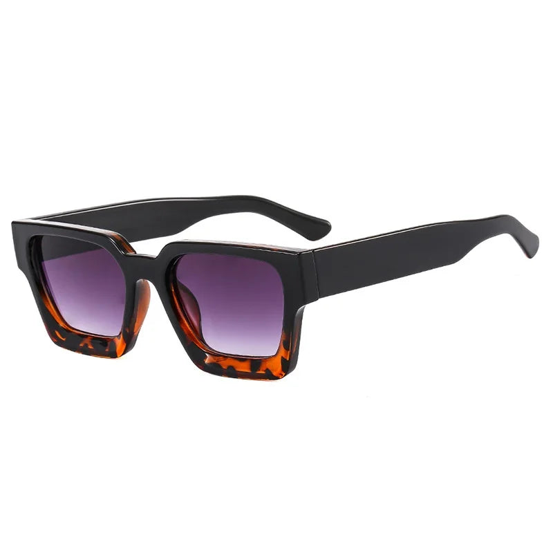 Sunglasses with black frame and leopard print lower accents on the frames over a white background