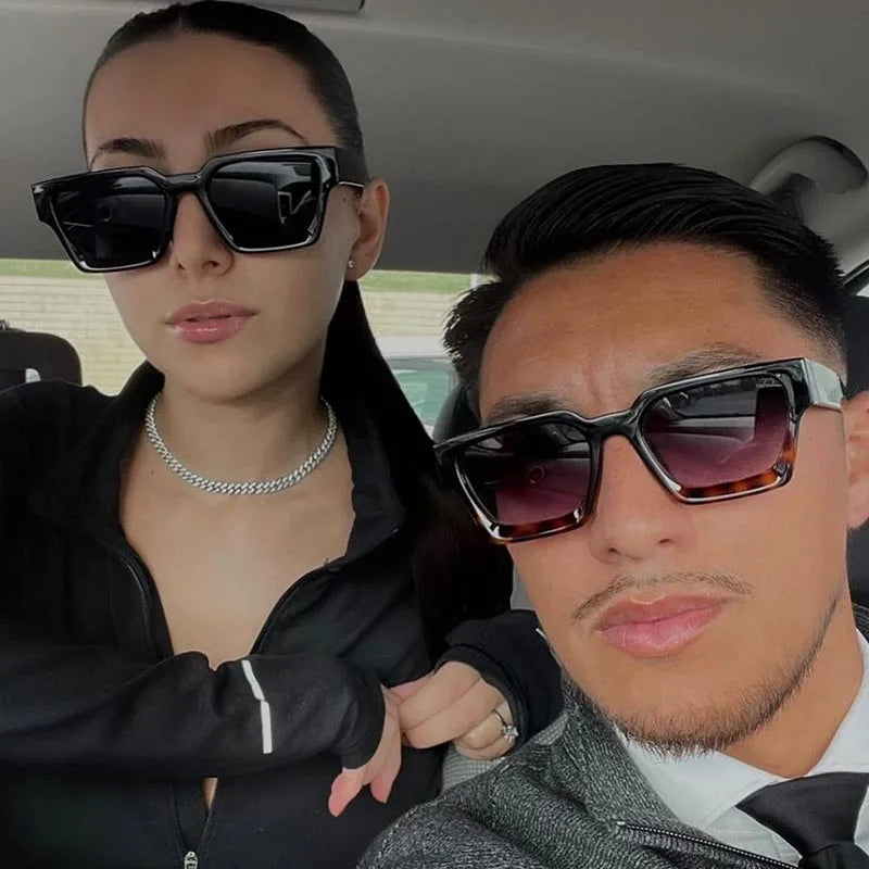 Two people wearing "Block Sunglasses Square Frame — Stylish Designer Shades" sunglasses inside a vehicle.