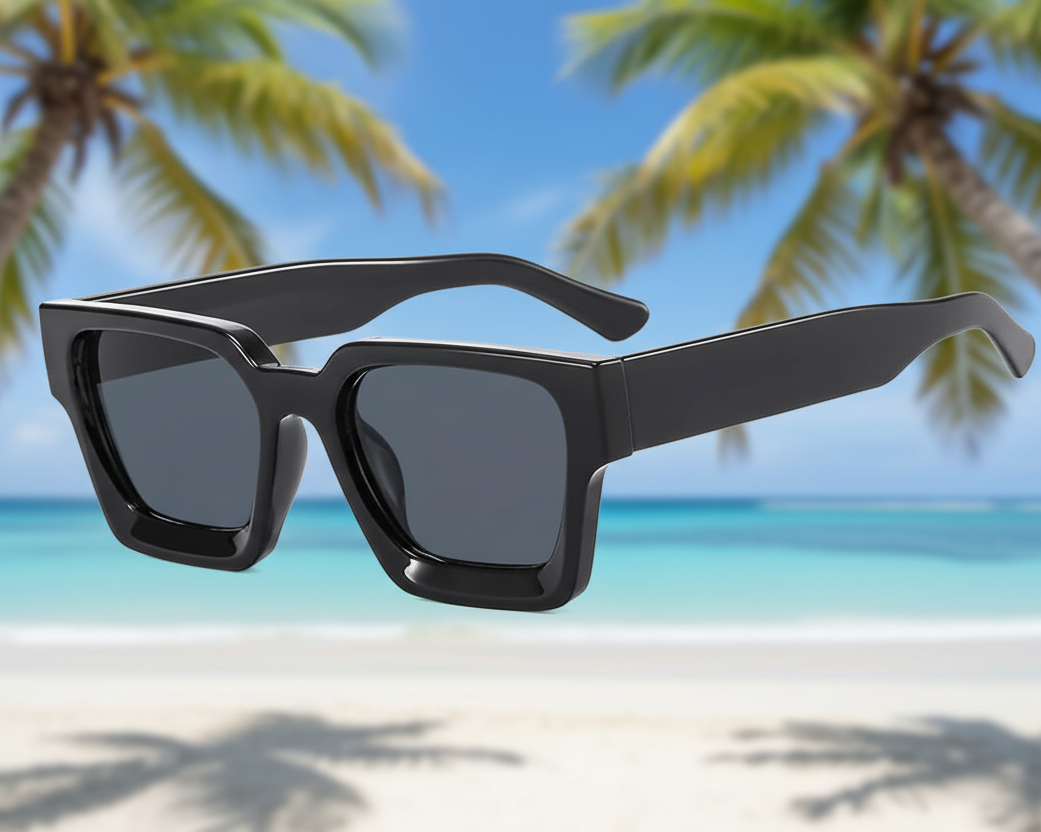 Black sunglasses with a beach and palm trees in the background