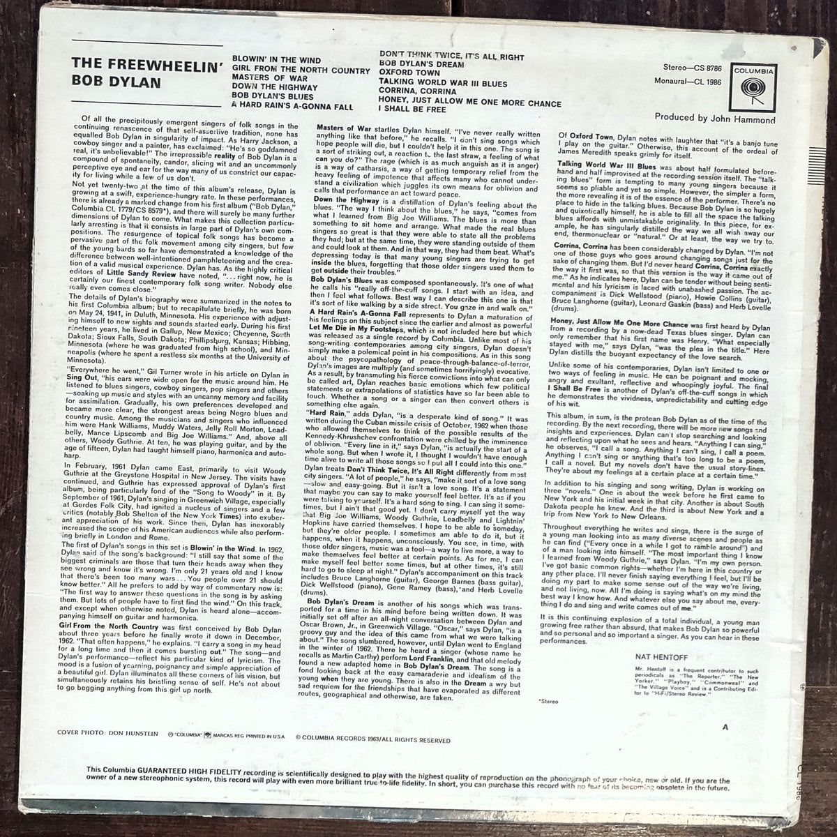 Image of The Freewheelin' Bob Dylan Vinyl Record featuring the full back cover over woodgrain background.