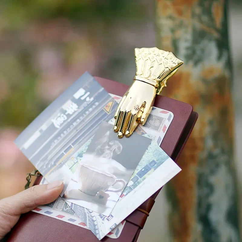 Vintage gilded brass hand-shaped notebook clip for book decoration.