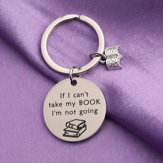 Keychain with 'If I can't take my BOOK, I'm not going' text on a purple background