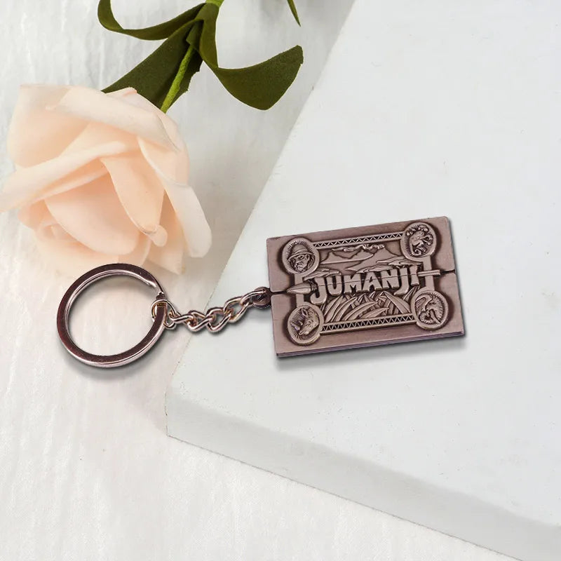 Jumanji keychain on a white surface with a rose