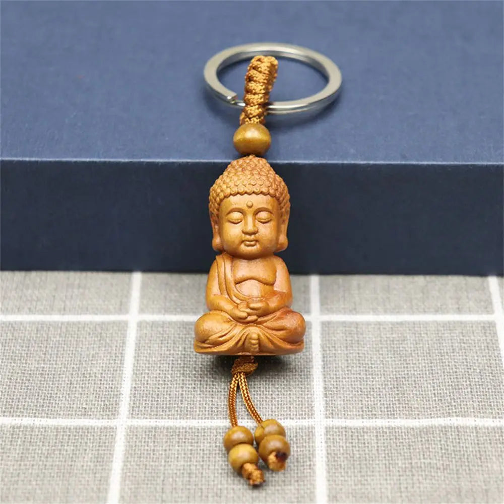 Hand-carved wooden Buddha keychains with prayer and meditation poses