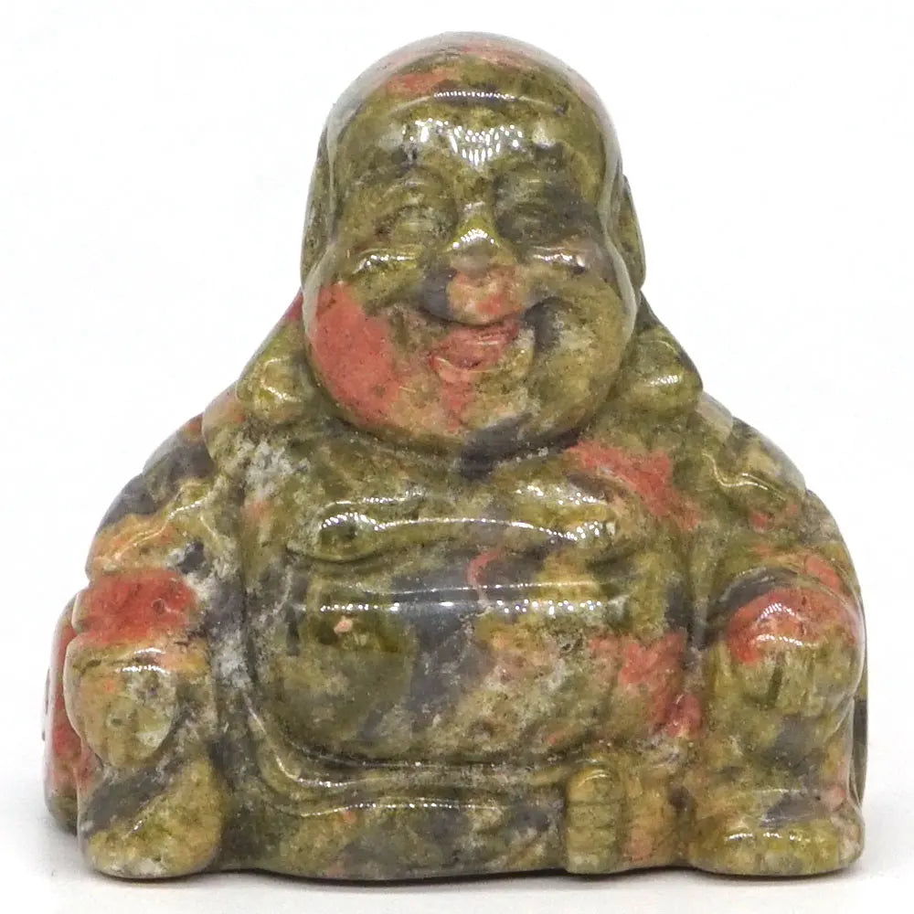 Carved stone Buddha figurine with green and red hues on a white background