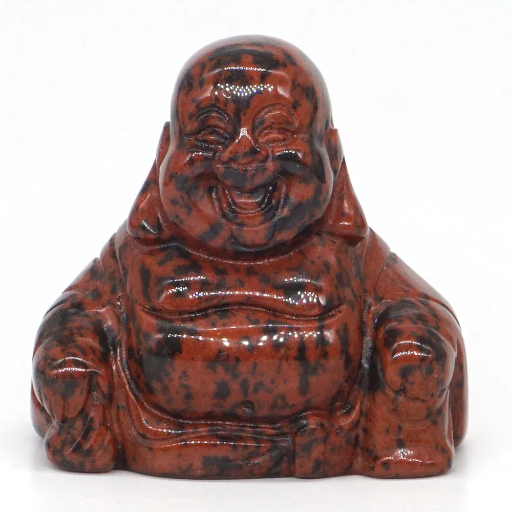 Red and black speckled Buddha statue on a white background