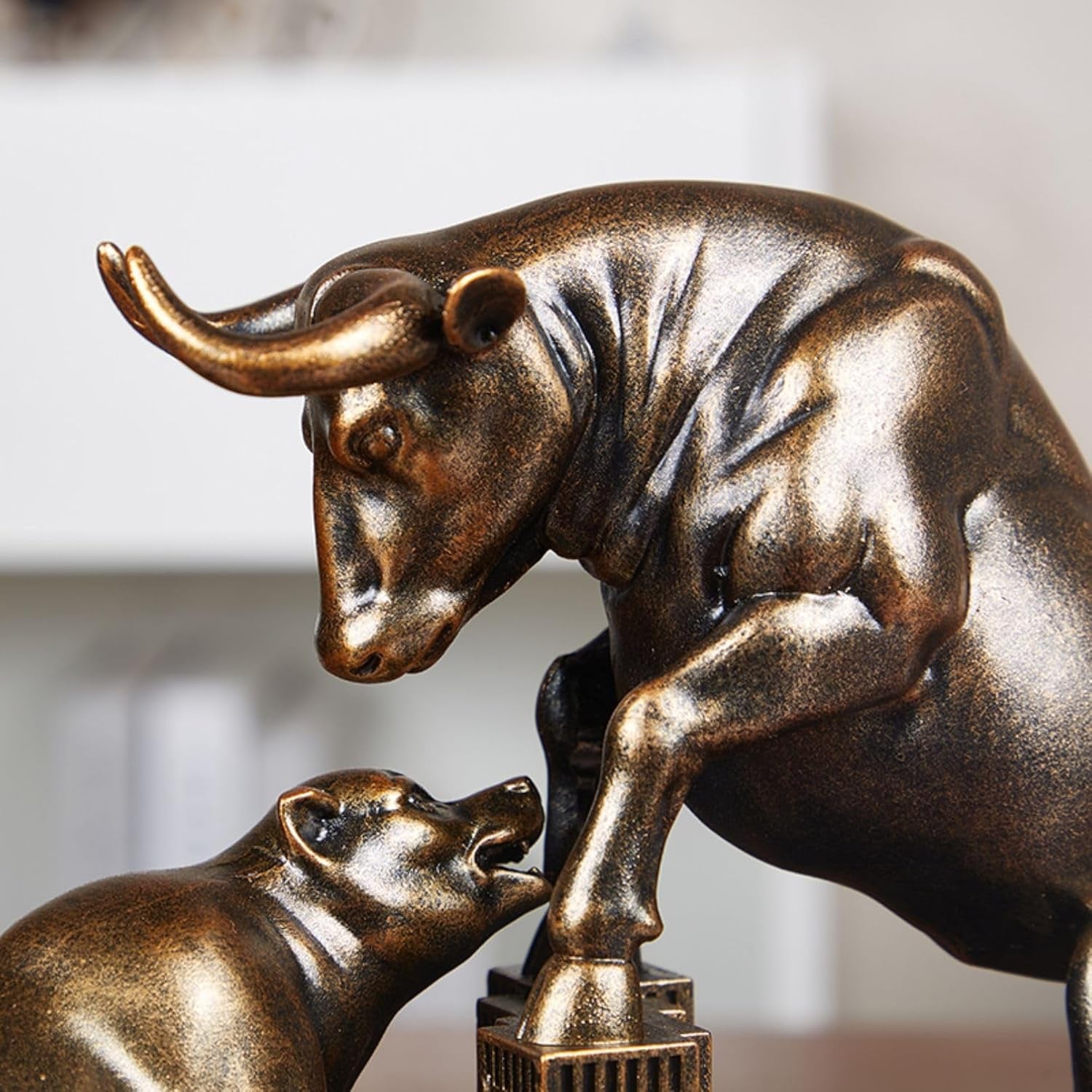 Close up of bronze bull and bear stock Market desk statue.