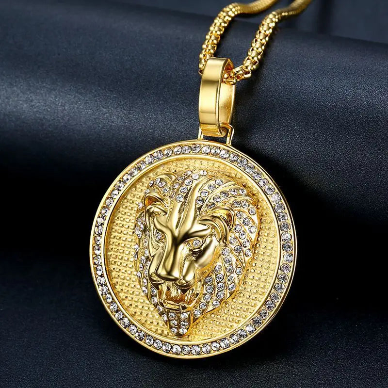Gold lion head pendant necklace on a dark fabric background