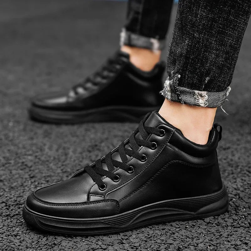 Black leather sneakers worn on a dark textured surface