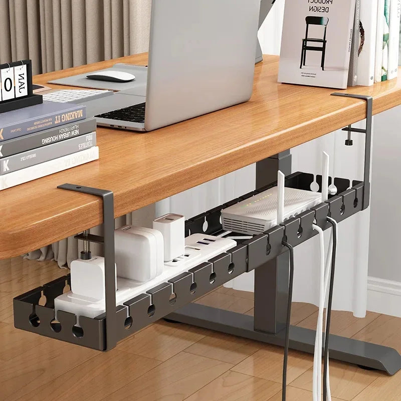 Desk with a cable management tray underneath, holding various electronic devices.