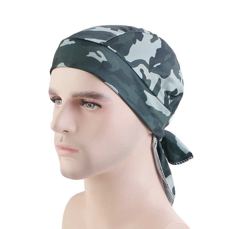 Mannequin head wearing a camouflage-patterned headscarf on a white background