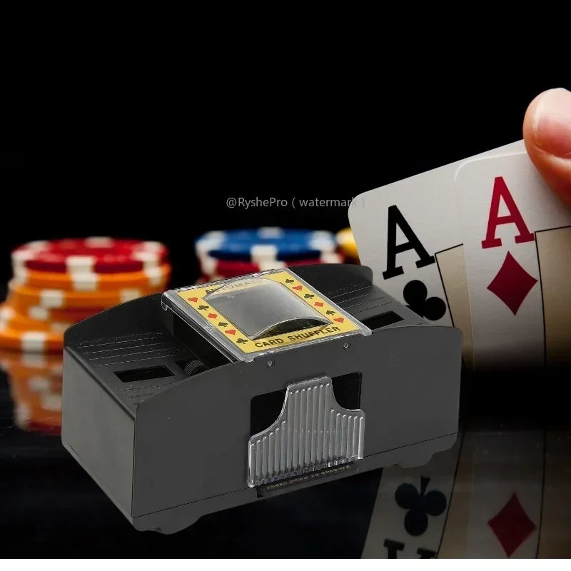 Card shuffler with playing cards and poker chips on a black background