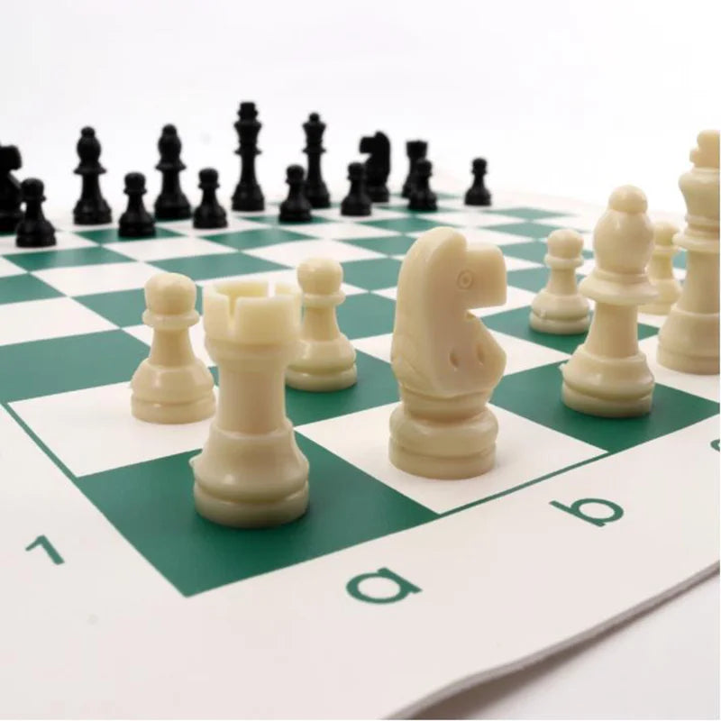 Chessboard with black and white pieces on a green and white checkered board