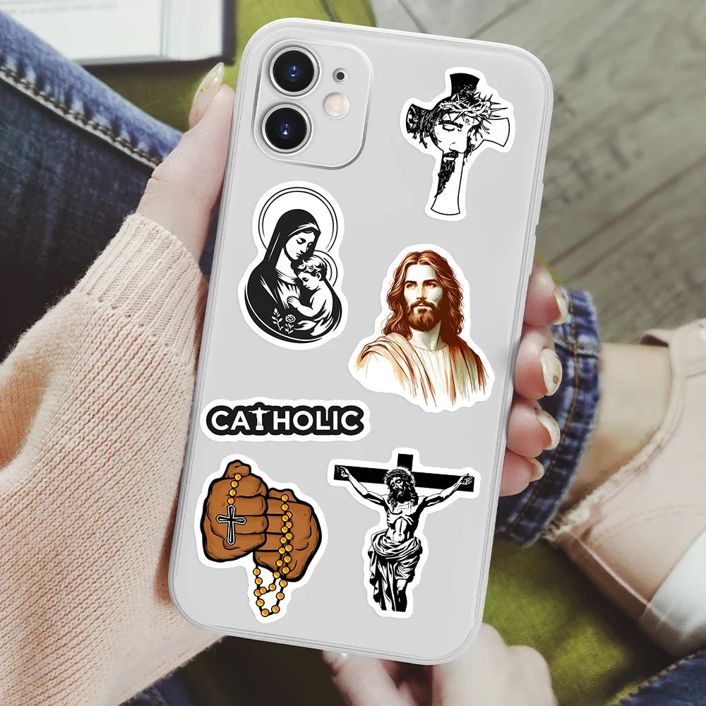 Phone case with Catholic-Christian themed stickers held by a person.