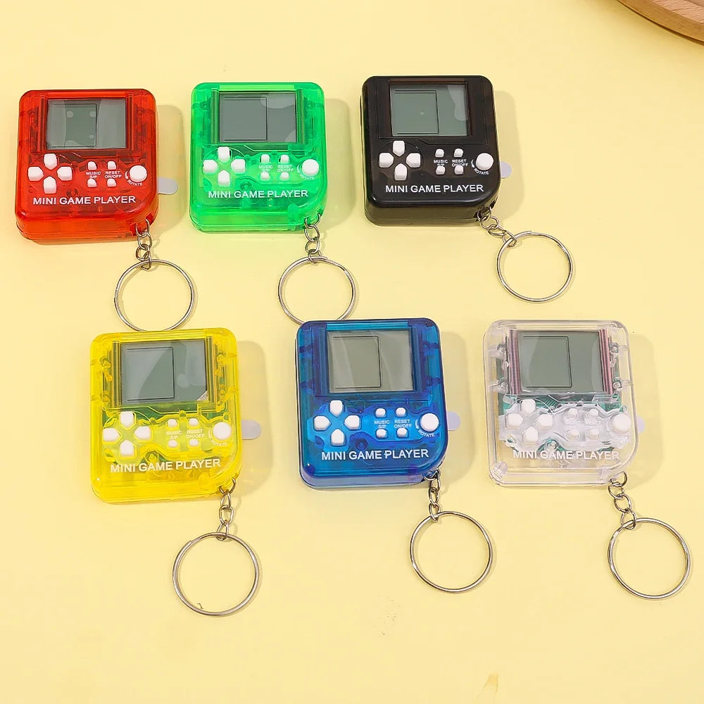 Set of six colorful mini game players on keychains over a yellow background