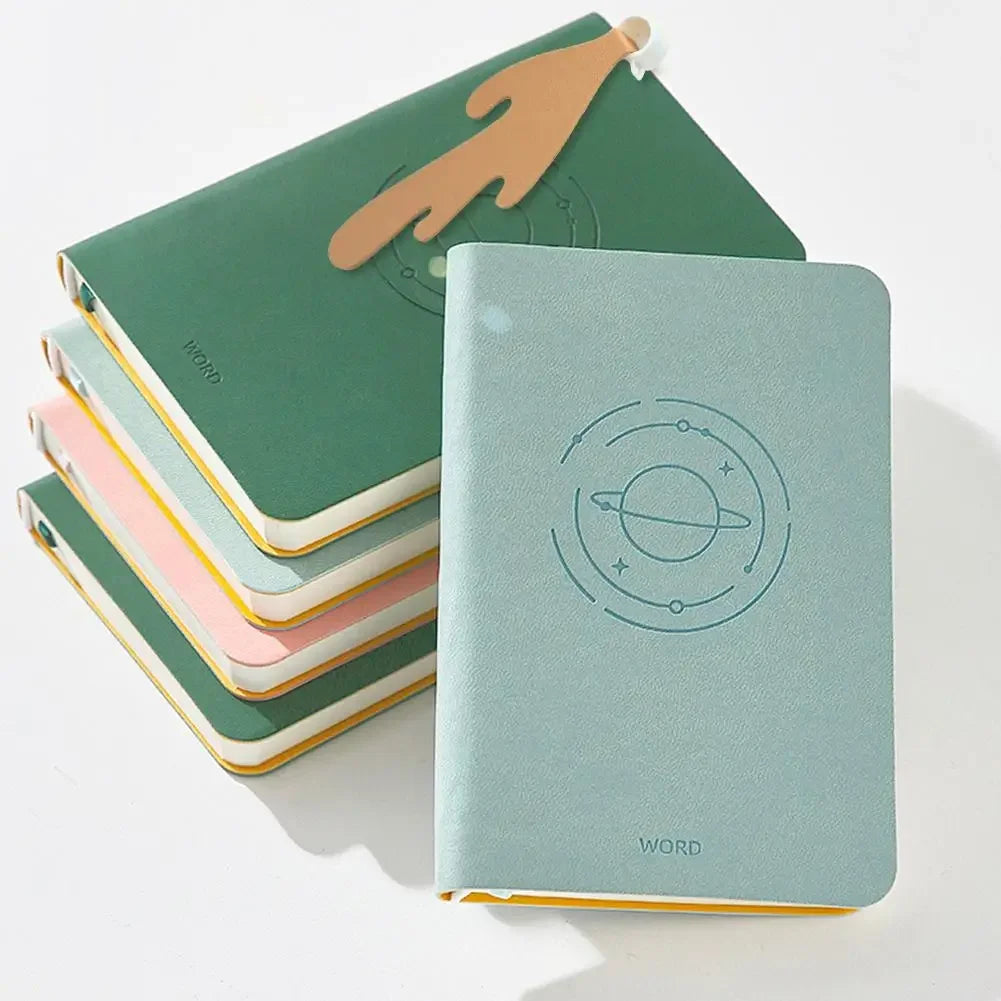 Set of colorful notebooks with spilling coffee cup cartoon bookmark and books with embossed designs on a white background.