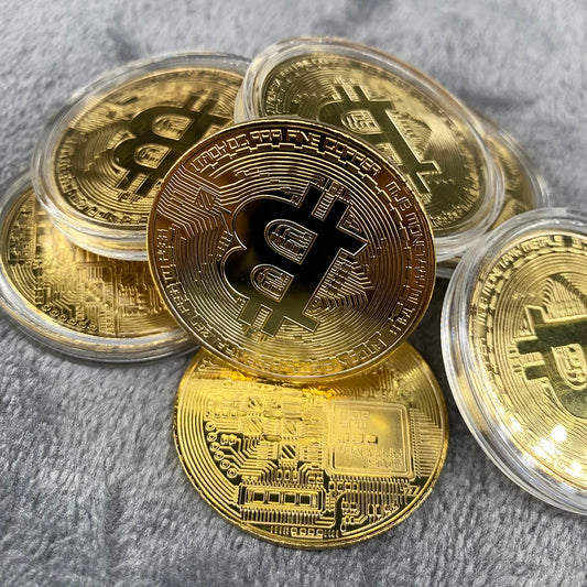 Gold coins with Bitcoin symbol on a gray surface