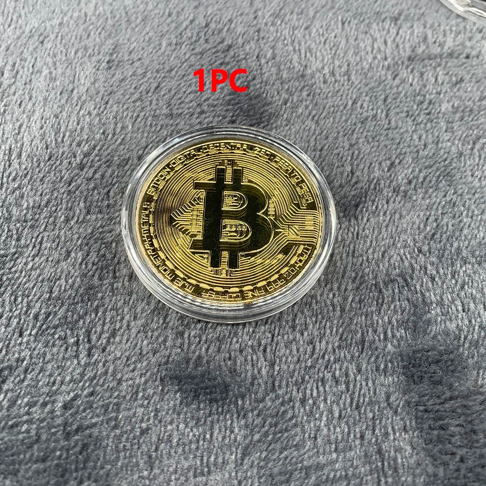 Gold Bitcoin coin in a clear case on a gray textured surface with '1-Piece' text.