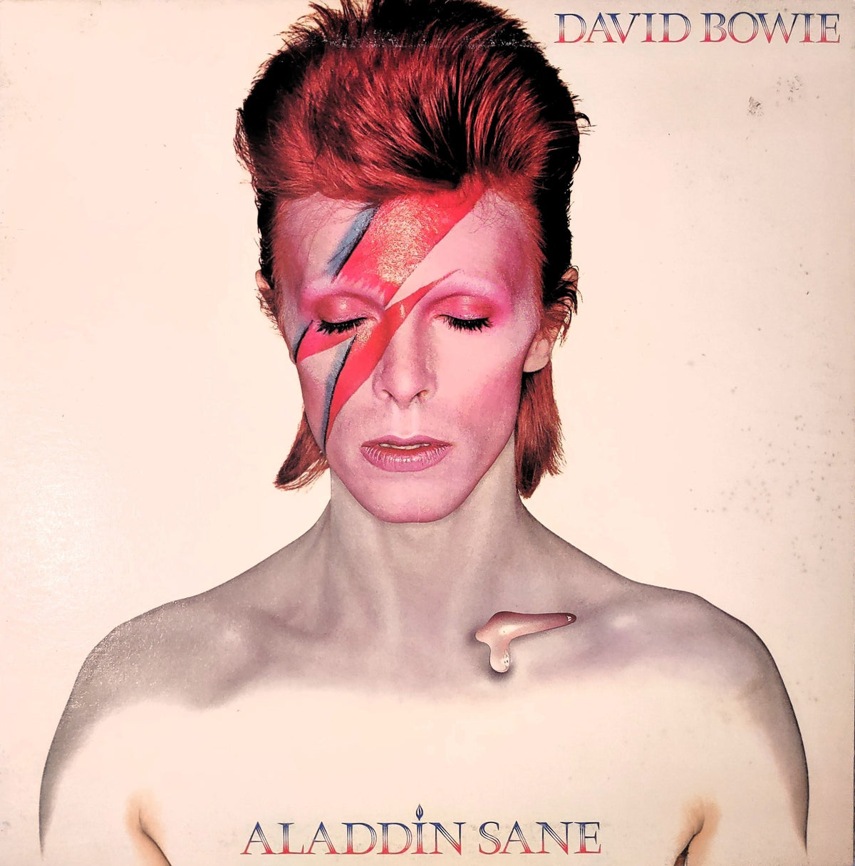 Front cover of the David Bowie album Aladdin Sane, 1973 US first printing. Cover art features a colorful illustrated David Bowie with vibrant lightning bolt drawings.