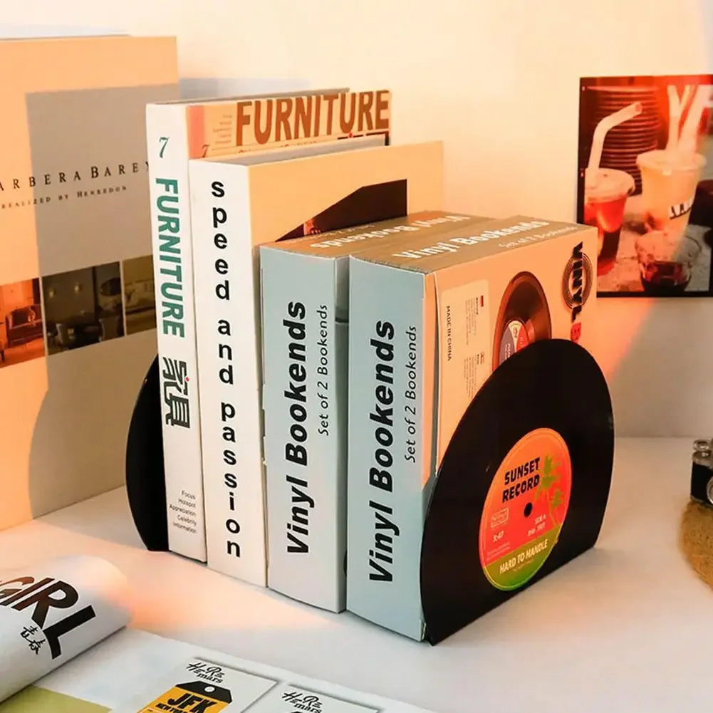 Vinyl record bookends on a shelf with books and a magazine.