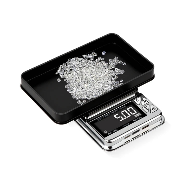 0.00 Digital scale with a black tray holding small diamonds on a white background