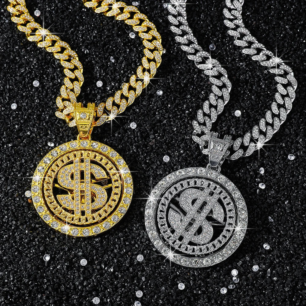 Gold and silver dollar sign pendants on chains against a black background with glitter.