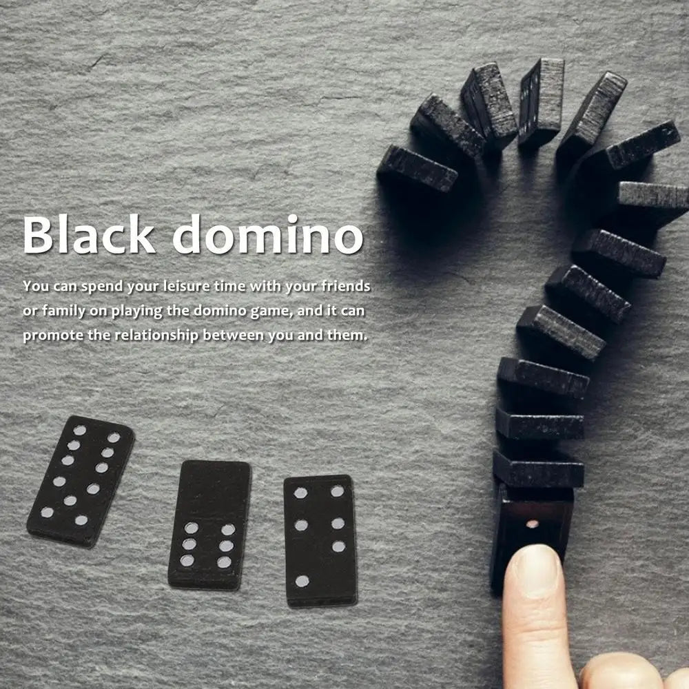 Black dominoes on a gray surface with text about playing dominoes.